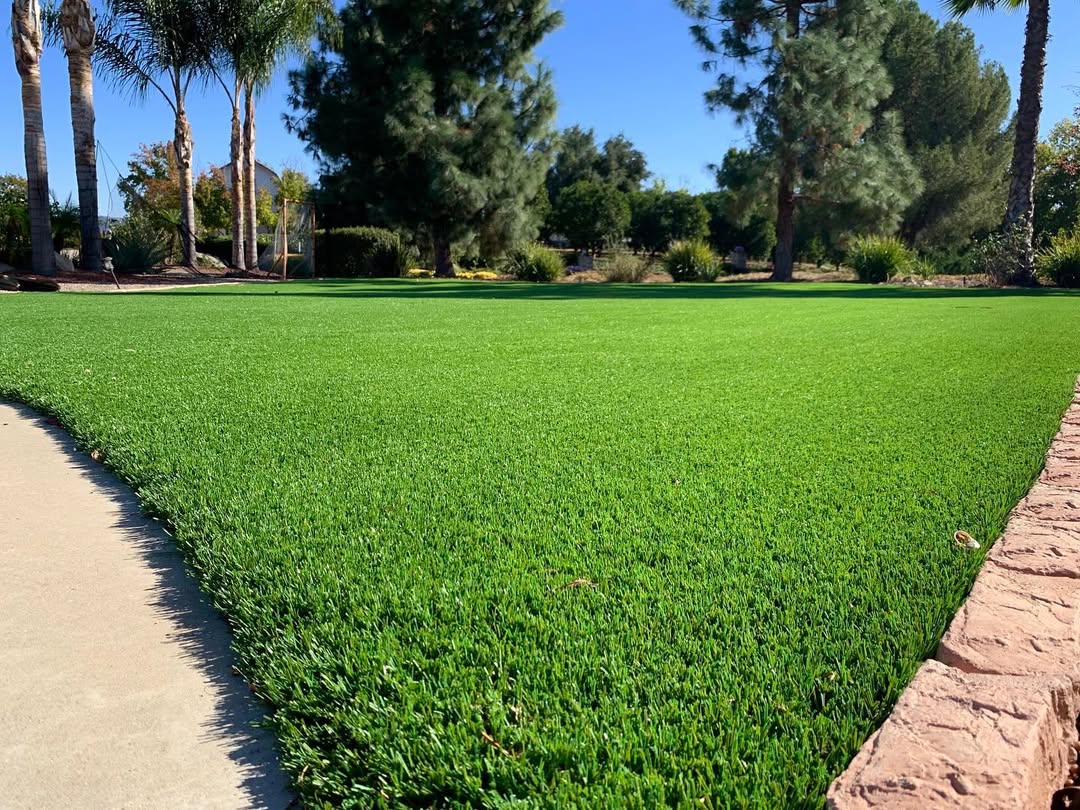 Backyard with vibrant artificial grass ideal for relaxation and play