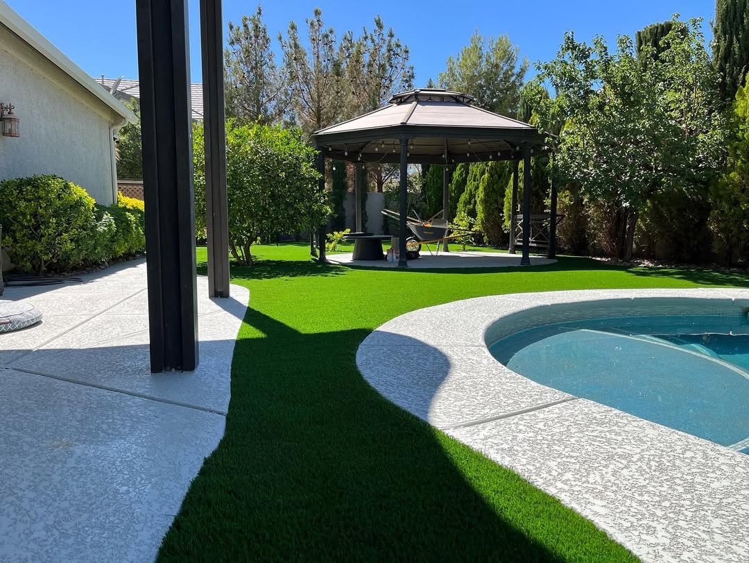 Backyard with lush artificial grass and a charming gazebo