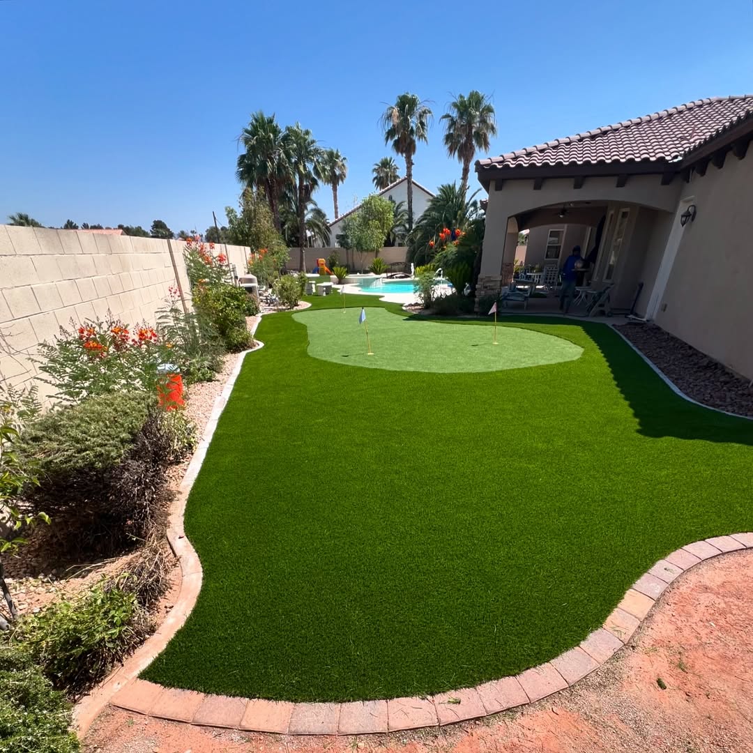 Backyard with artificial grass and a sparkling blue pool